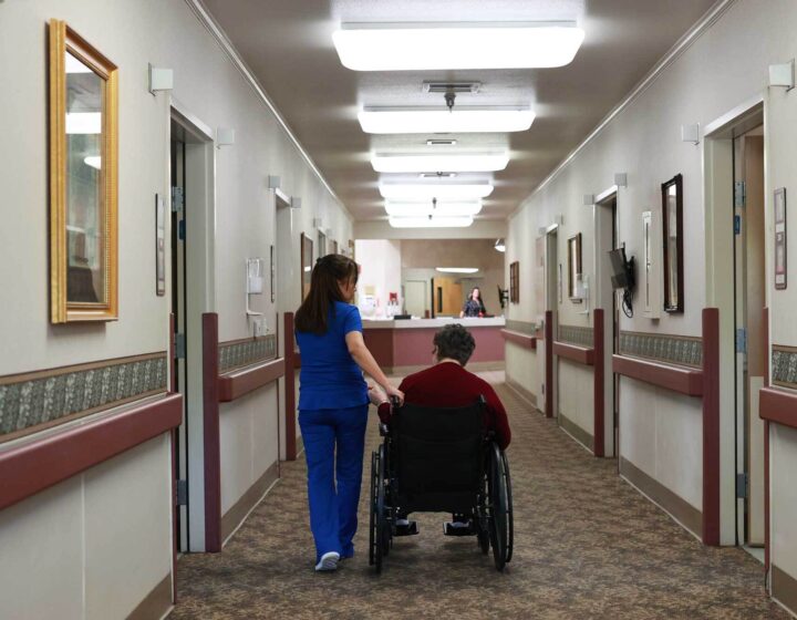 A nurse walks with a resident at Bethany